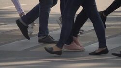 People crossing crosswalk in city. Legs of Crowd People Walking on the Pedestrian Crossing. Slow Motion Stock Footage
