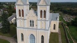 Christianity church, road and cemetery in province, Lithuania, aerial Stock Footage