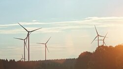 Wind turbines and agricultural fields on a summer day Stock Footage
