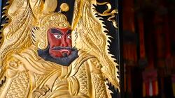 Wooden gates decorated with traditional chinese ancient holy door gods guardians Qin Shubao and Yuchi Jingde Gong. Entrance to chinese shrine with golden warrior protector angel. Tang Dynasty General Stock Footage
