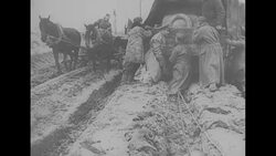 During World War II, German military vehicles move through mud and water created by melting snow in Russia News Clip