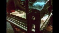 UNITED STATES 1960s: Hand press roller on picture, wipe of picture. Stock Footage