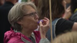 People with banners protesting against the US President Donald Trump News Clip