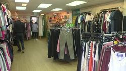 Designer clothing on sale in a Mind charity shop News Clip