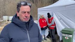 Red Cross volunteers help new arrivals as they cross the border from Ukraine into Kroscienko, Poland News Clip