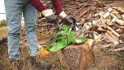 Lumberjack fixing / maintain the chainsaw outdoors. Stock Footage