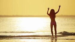 Asian Chinese female in bikini on ocean beach Stock Footage