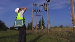 Electrician talking on smartphone and checking transformer Stock Footage