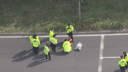 Aerial view of police arresting climate protesters who block M25 junctions during rush hour News Clip