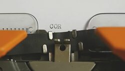 Close up footage of a person writing CORRUPTION on an old typewriter, with sound Stock Footage