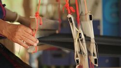 Traditional textile manufacture in craft village where old women work on wooden weaving loom machines and spin yarn creating silk or cotton fabric. Silk weaving in Thailand. Stock Footage
