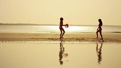 Multi ethnic girlfriends on ocean beach at sunset Stock Footage