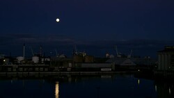 Full Moon Rising Above the Trading Port. Stock Footage