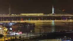 Illuminated Golden Horn Metro Bridge, blurred lines of busy traffic in Istanbul Stock Footage