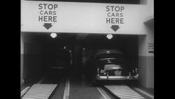 United States, c.1951: A customer leaves her car to an attendant at a parking garage Stock Footage