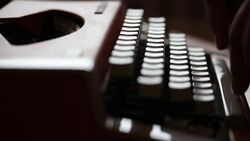 Side shot of a person writing on an old typewriter, with sound... Stock Footage