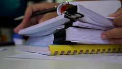Businessman hands holding pencil for working in Stacks of paper files searching information business report papers, professional working startup for investment development to success on computer desk. Stock Footage