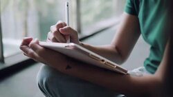 Designer drawing a sketch on tablet using stylus at city Stock Footage