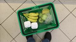 Woman with food basket at grocery store or supermarket Stock Footage