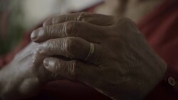 Old woman touching wedding ring on finger feeling sad Stock Footage