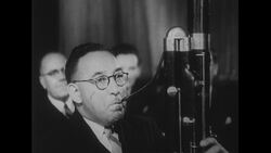 Australia, c.1951: A bassoon player plays a piece of music in an orchestra Stock Footage