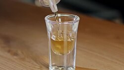Slow motion of a whiskey shot poured into a glass Stock Footage