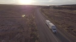 Aerial Drone Footage of Semi-Trucks Rolling Down the Highway Stock Footage