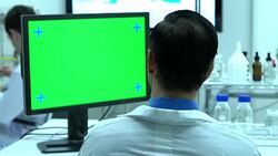 Scientist male talking about working in modern laboratory or medical center. Background monitor green screen. Concept of science, testing development and lab industry. Stock Footage