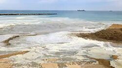Pan: Construction Crew Pumping Sand on Beach Stock Footage
