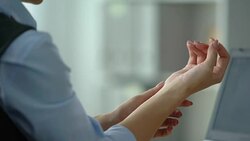 Female office manager typing on laptop, feeling wrist pain, joint inflammation Stock Footage