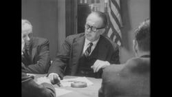 1960s: Group of men sit around table, smoke cigarettes Stock Footage