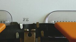 Close up footage of a person writing FEMINISM on an old typewriter Stock Footage