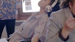 Serene creative businesswoman listening to music with headphones in office Stock Footage