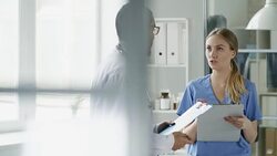 Two Multiethnic Doctors Discussing Work Stock Footage