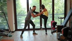 Private coach helping a athletic woman with stretching Stock Footage