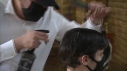 Men having haircuts in a barbers' after lockdown easing News Clip