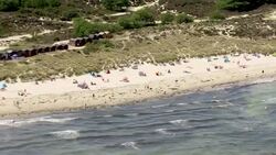 Aerial shots - people on beach News Clip