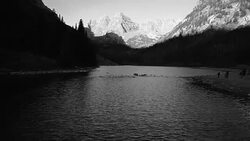Amazing Sunrise at The Maroon Bells of Aspen , Colorado Aerial drone view backing up to the water's edge Stock Footage