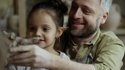 Father and Daughter Looking at Wet Clay Sculpture Stock Footage