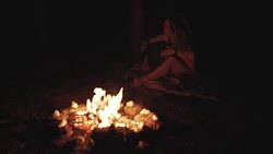 Beautiful young hippie woman with dreadlocks playing on djembe. Funky woman drumming in nature on an ethnic drum with a human skull at night Stock Footage