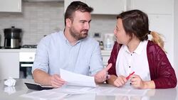 Happy couple calculating home bills Stock Footage
