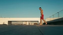 young man jumping to the rooftop pool above the city Stock Footage