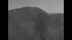 Soldiers evacuate wounded on stretchers from fighting on Old Baldy Hill during Korean War News Clip