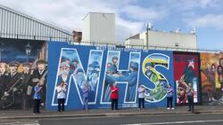 Healthcare workers pose in front of NHS mural in Belfast News Clip