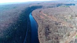 Aerial view of Pocono Mountains, Appalachian, in late fall sunny day. The abandoned demolished old bridge over Hickory Run river Stock Footage