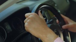 Man hands holding a steering wheel confidently Stock Footage