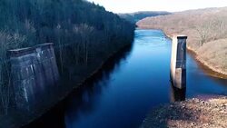 Aerial view of Pocono Mountains, Appalachian, in late fall sunny day. The abandoned demolished old bridge over Hickory Run river Stock Footage