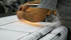 Technician is doing maintenance and repair of weaving loom machines in textile factory Stock Footage
