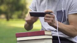 Teenager put aside books with homework to play video game, addiction concept Stock Footage
