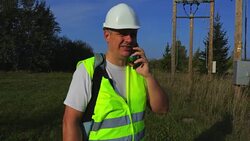 Electrician with smartphone at the transformer Stock Footage